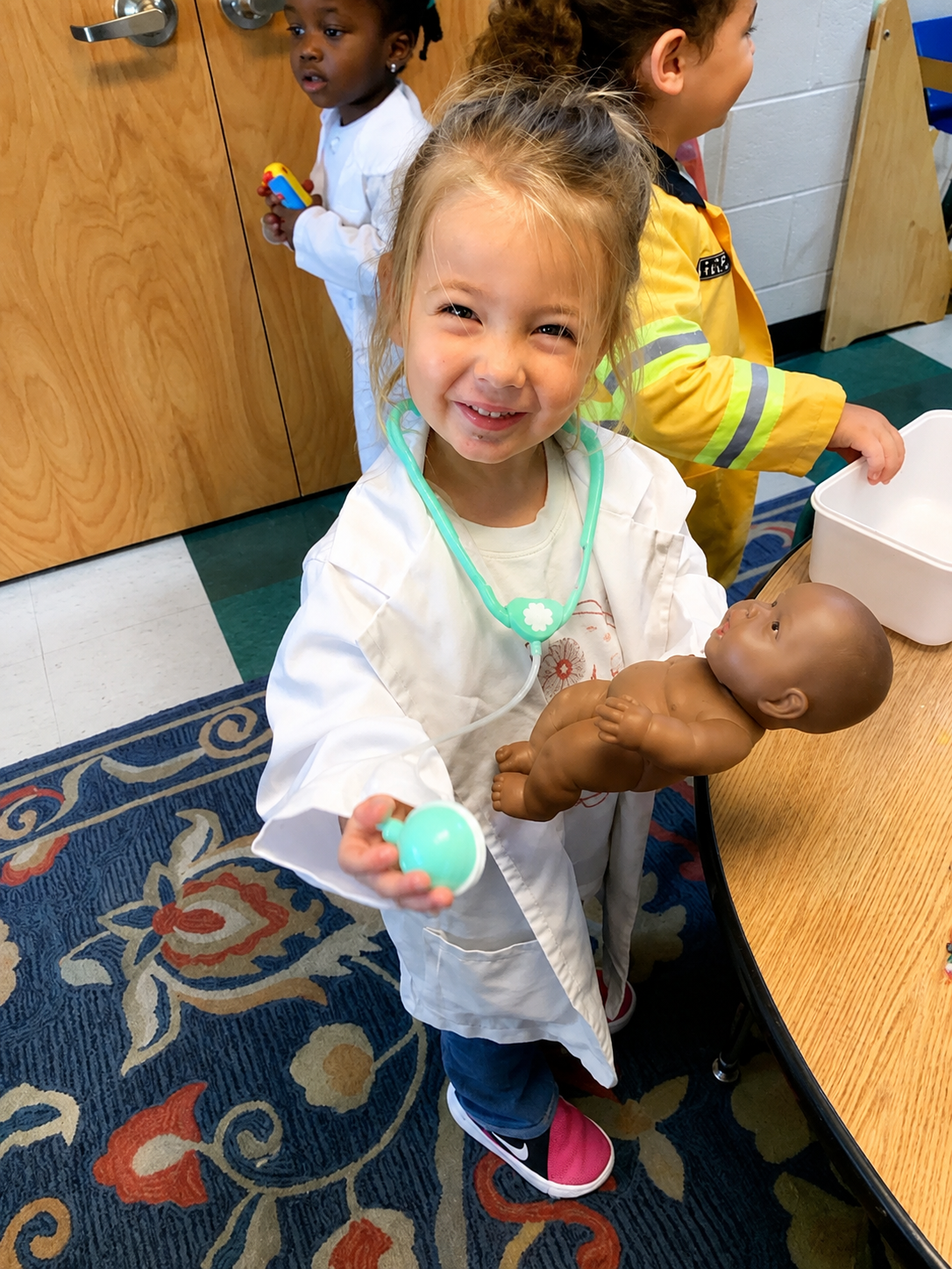 a kid playing baby doll